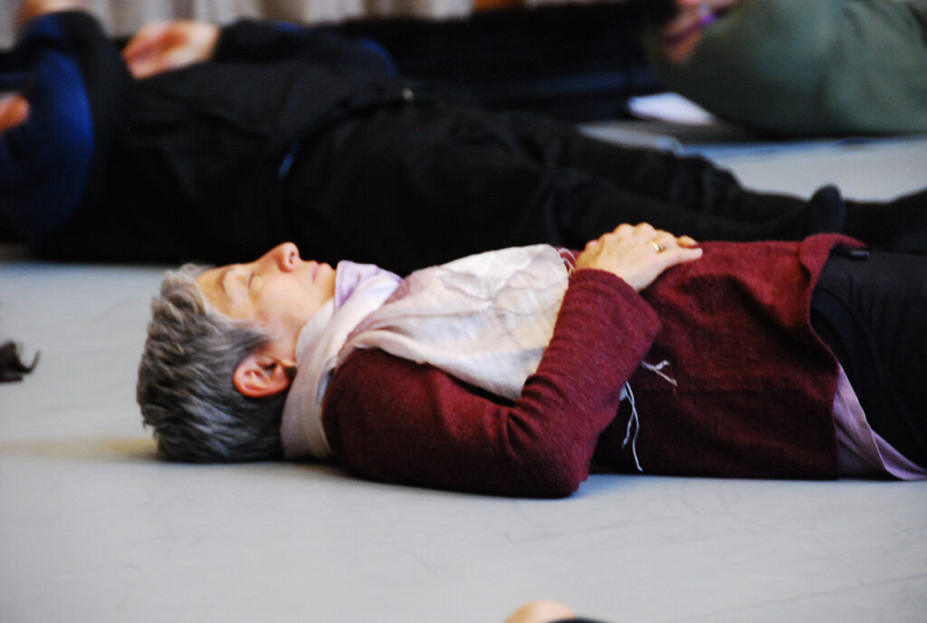 Woman in a maroon coat lying on the floor